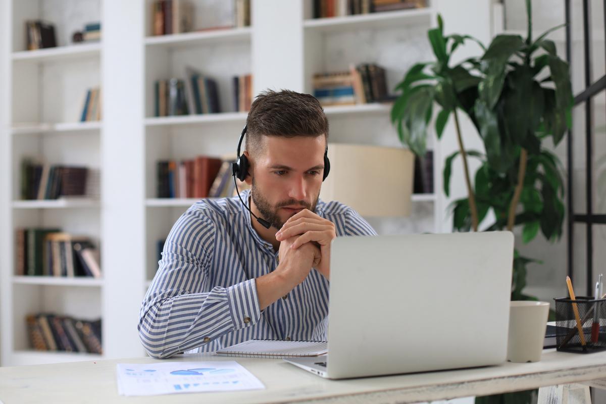 Man with headphones looking at computer