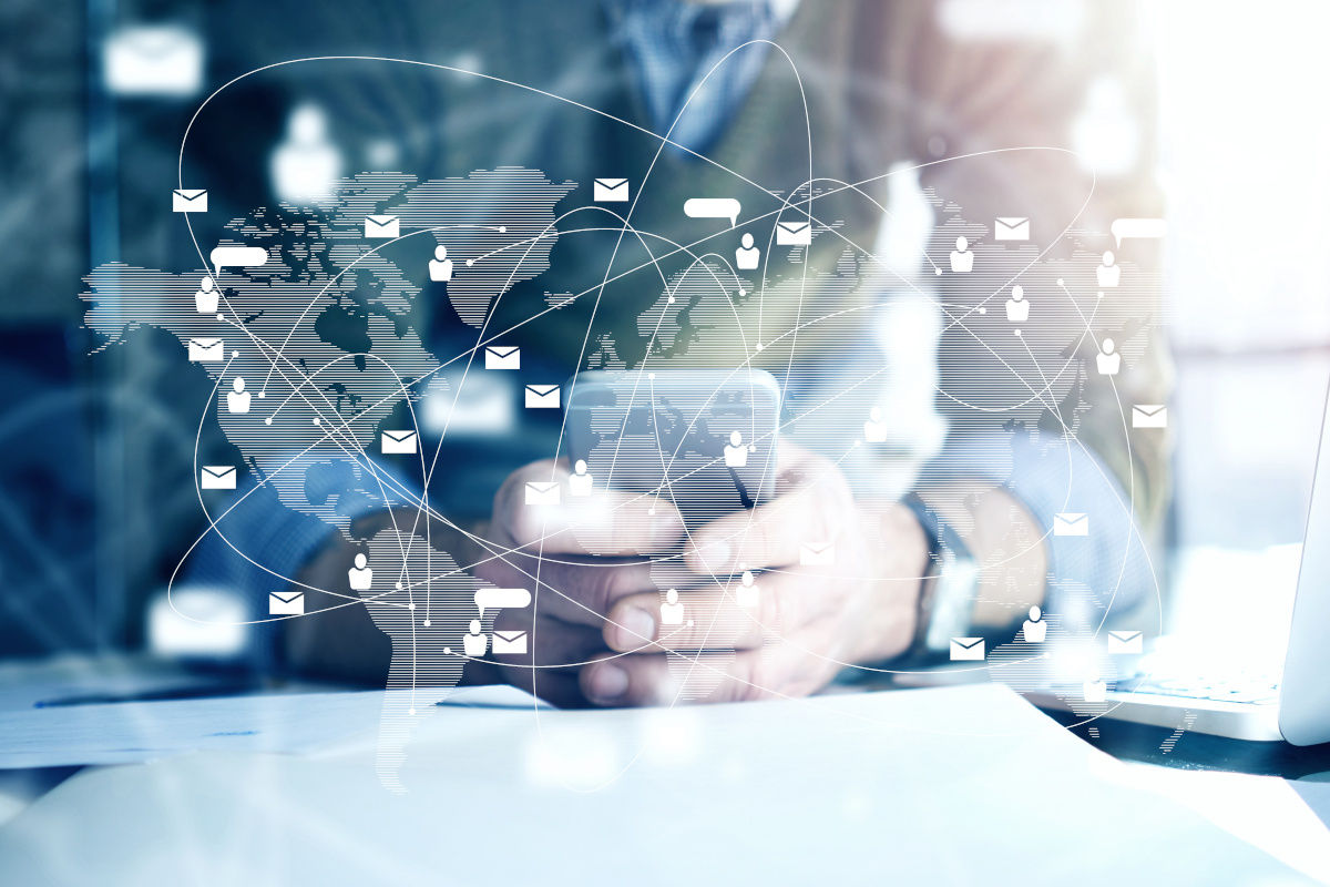 Man using mobile phone with communication icons floating aroun him