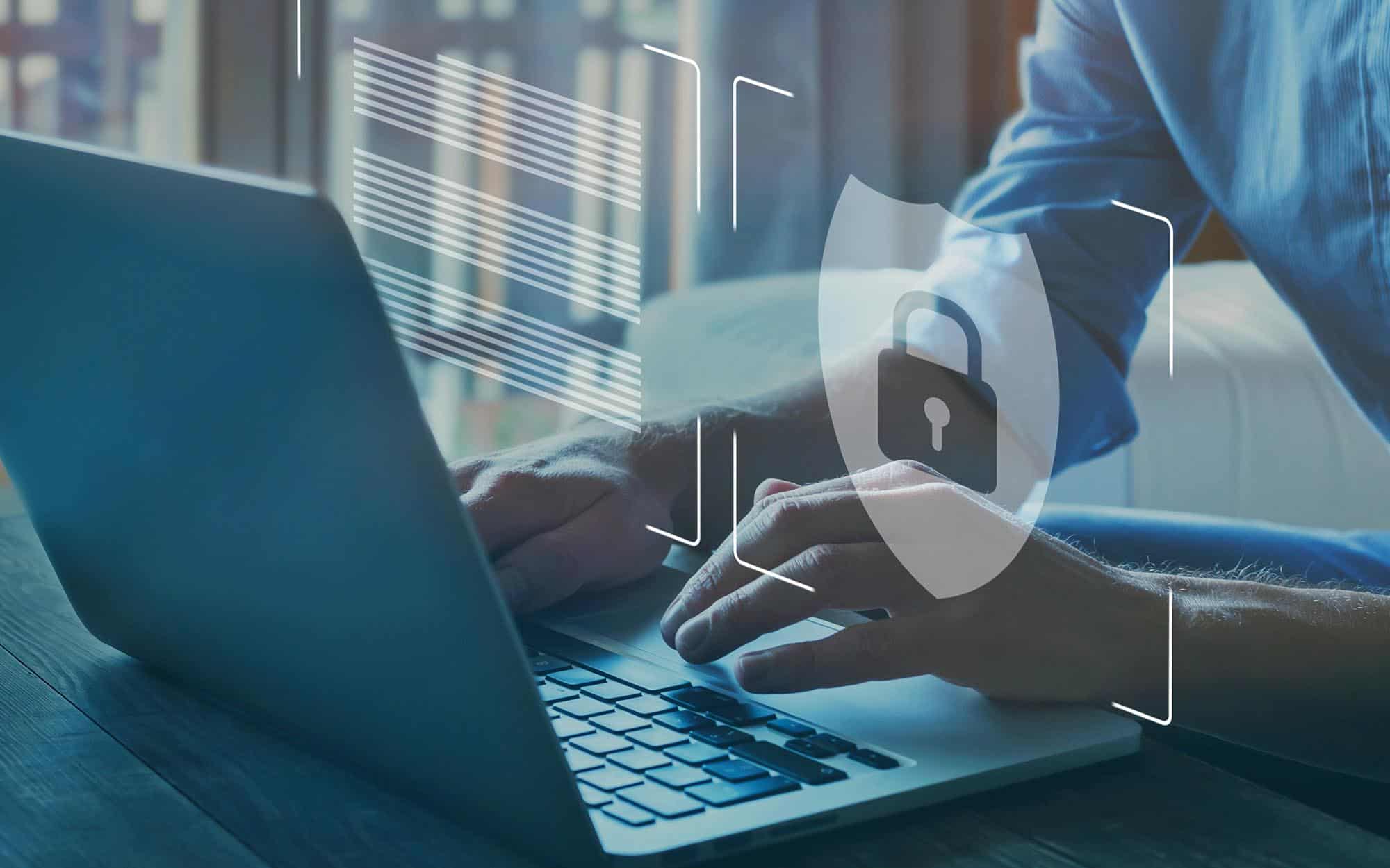 Man using computer protected by digital security